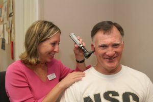 Patient receiving hearing aids from experienced audiologists in Denver, PA.